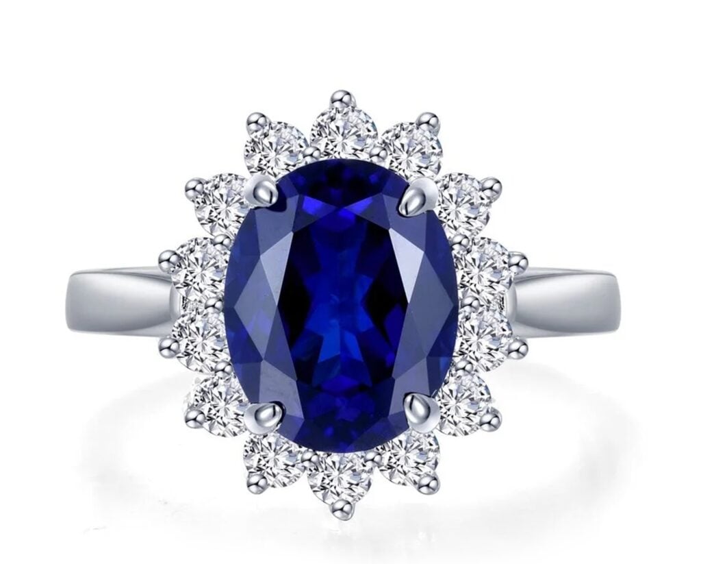 Plata con acabado de Platino con 1 Zafiro de Laboratorio corte oval de 10 x 8 mm y 14 Moissanitas corte brillante