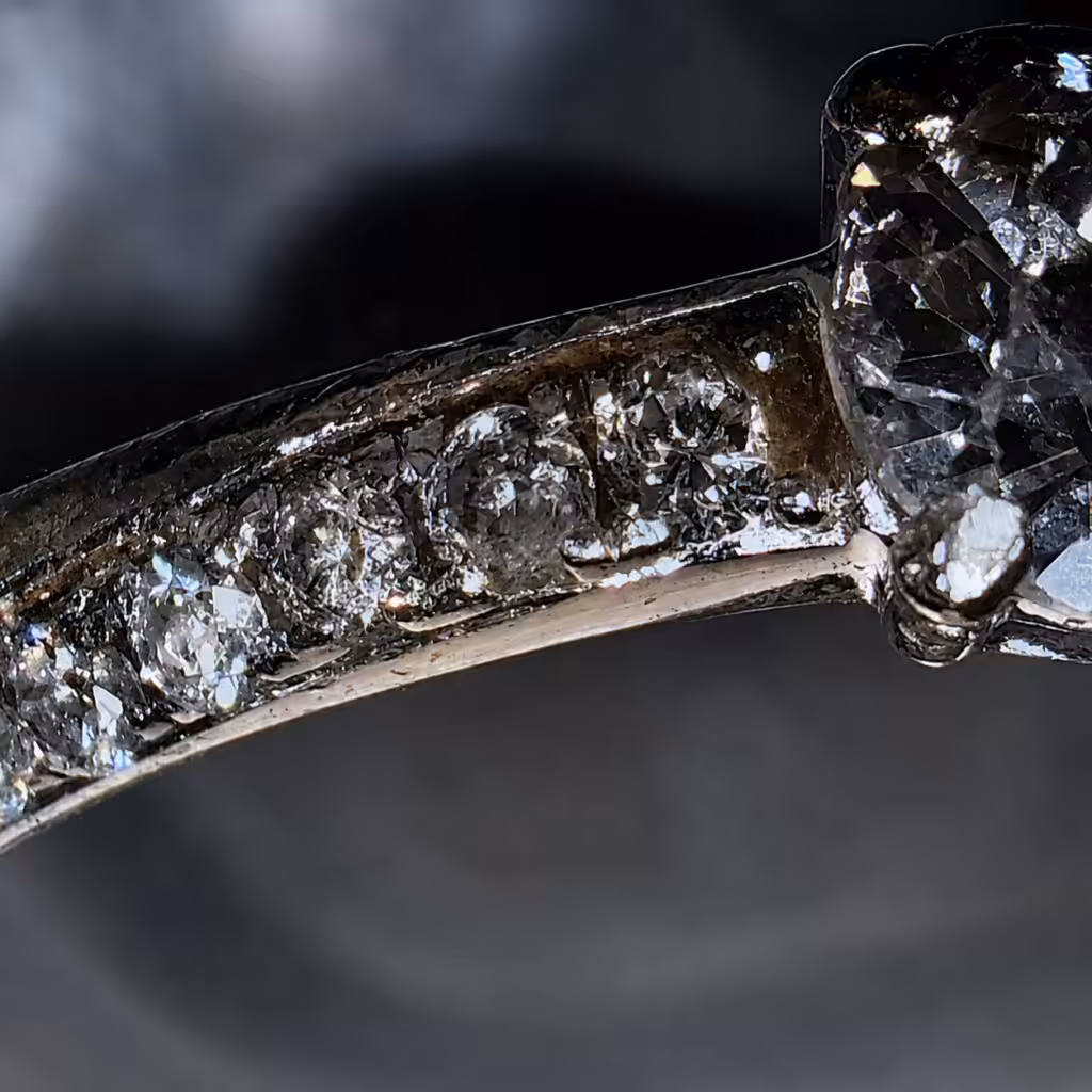 Desgaste y residuos en un anillo de oro observados con aumento.